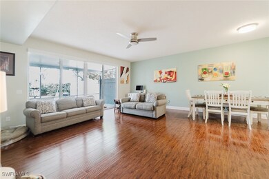 Living area with a ceiling fan, baseboards, and wo