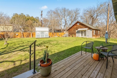 View of yard with a fenced backyard, a deck, fren