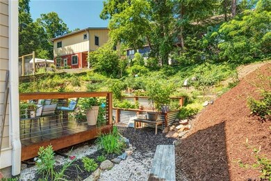 House is position on lot for maximum use of outdoor space. Temporary silt fencing because of new construction on hill above.