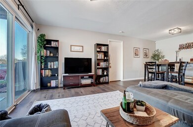 Living room opens to dining area. Door in this pho
