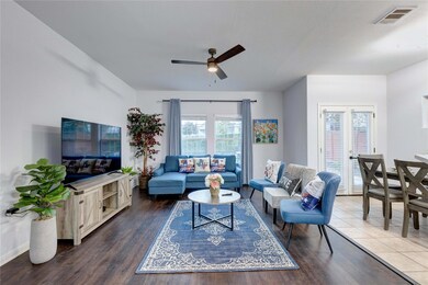 Living area with ceiling fan and wood finished fl