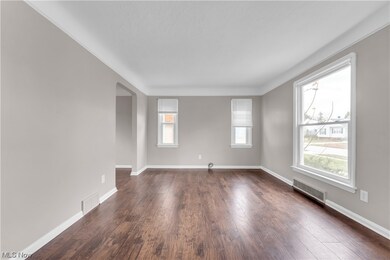 Unfurnished room with dark hardwood / wood-style floors