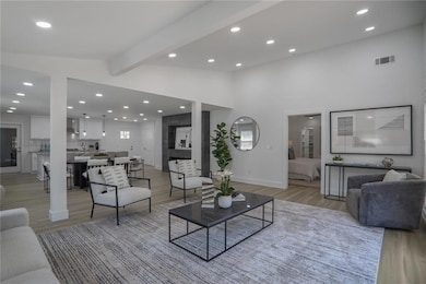 Living room featuring visible vents, recessed lighting, and light wood-type flooring