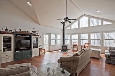 The Great Room features large windows to enjoy the views, beautiful hardwood floors, a cathedral ceiling, and an HeartStone Wood Burning Stove!