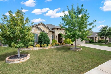 View of front of home with a garage and a front la
