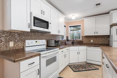 Don't miss the action on the lanai with the corner windows in this kitchen.
