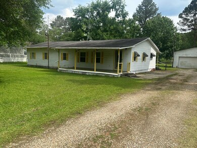 View of front facade with a porch, a front lawn, a