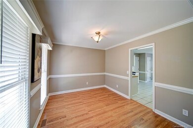 The formal Dining Room features crown and chair ra