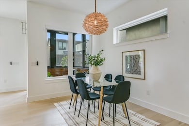Dining area with baseboards, light wood-style flo