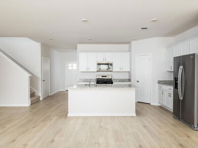 Kitchen featuring visible vents, a center island 