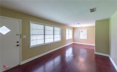 LIVING DINING COMBO WITH WOOD FLOORS AND TONS OF N