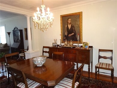 Dining Room with Wood Floors and Crown Moldings