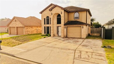 View of front facade with brick siding and a garage