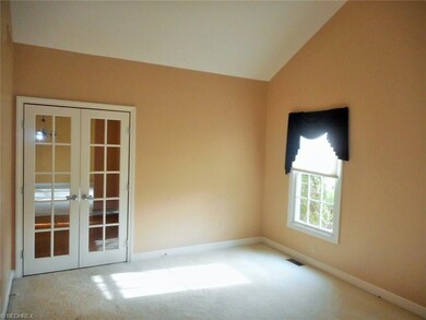 Living room off of foyer, vaulted ceilings and lig