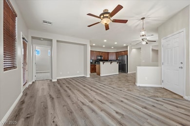 Unfurnished living room with a ceiling fan, light