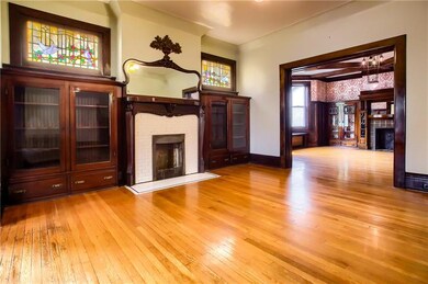 Living room with beautiful detailed mantle, built-