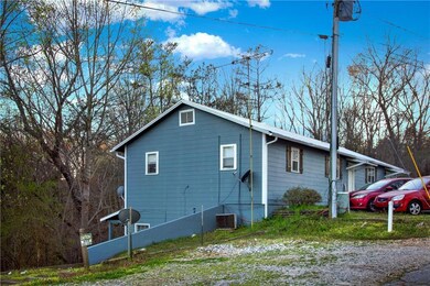 View of side of home featuring central AC