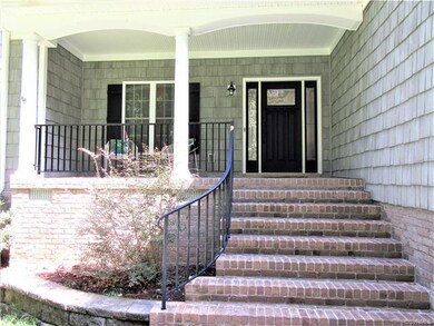 Covered Front Porch has Outdoor Lighting, Brick St
