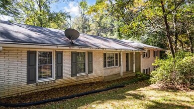 Back of property featuring brick siding