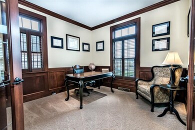 Handsome den with wainscoting, crown molding and p