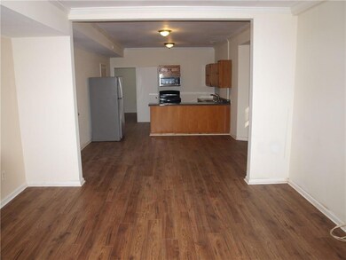 Kitchen with dark countertops, range, brown cabine