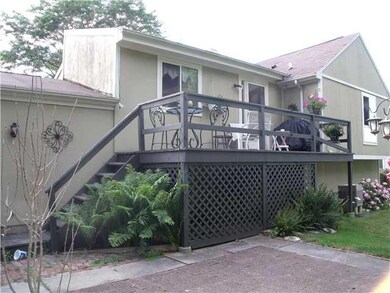 Exterior Back. Rear deck and stone patio.