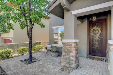 Entrance to property with stucco siding and stone siding