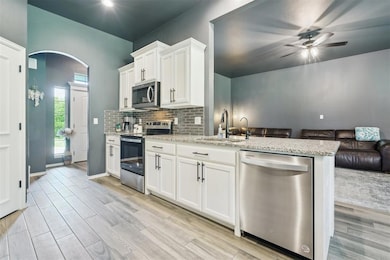 Kitchen featuring light wood-style flooring, a sin