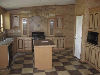 Kitchen with black microwave, a center island, dar