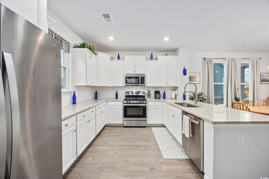 Kitchen with stainless steel appliances, light sto