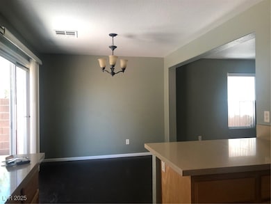 Kitchen with a chandelier, baseboards, decorative