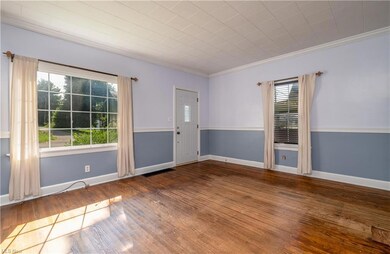 Wood floored empty room featuring ornamental moldi