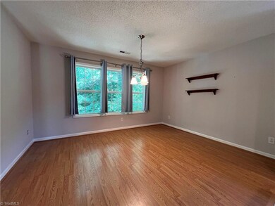 Large windows overlook lush back yard in the dining room.