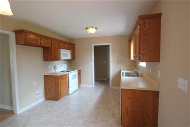 Kitchen features dishwasher, stove and microwave, as well as an adjoining dining room.