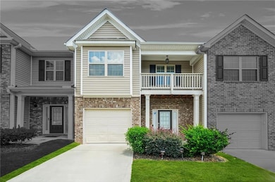 Craftsman-style house featuring a balcony, an attached garage, and driveway