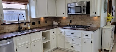 Gas cooktop and microwave complete this kitchen