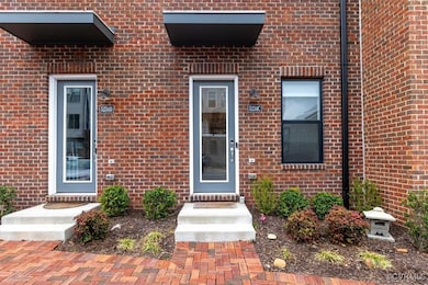 Doorway to property featuring brick siding