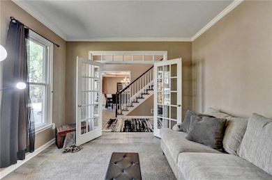 Living room featuring french doors, ornamental mol