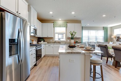 Open concept design with this large island gives plenty space for entertaining. Image is of model, colors may vary.