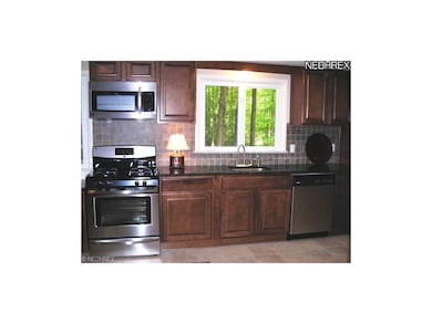 Kitchen with stainless appliances and granite tops