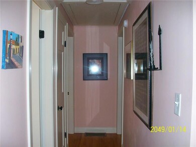 Hallway with hardwood floor.