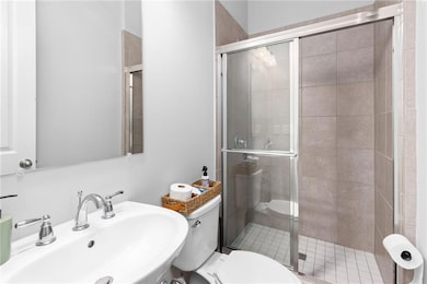 Bathroom with a sink and a stall shower