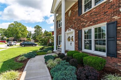 Meticulously manicured garden abound front and bac