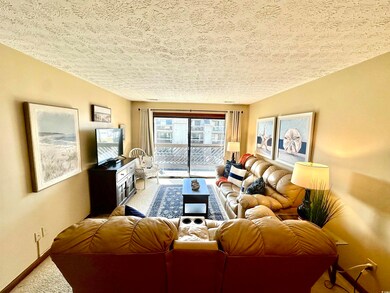 Living area featuring carpet flooring, baseboards,