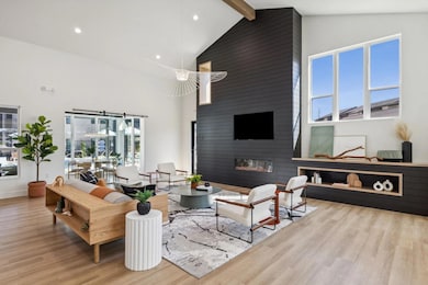 Living room featuring high vaulted ceiling, light 