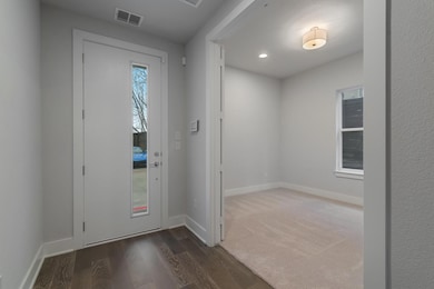Foyer featuring baseboards, wood finished floors, 