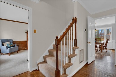 Staircase with ornamental molding and dark colored