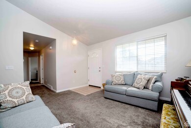 Living area featuring light colored carpet and lofted ceiling