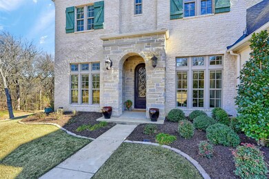 Stunning stone entranceway with beautiful landscaping