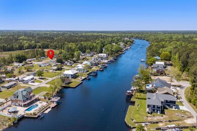 Drone / aerial view featuring a view of trees and a water view